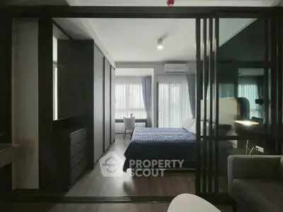 Modern bedroom with sleek design and large windows for natural light.