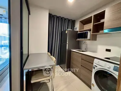 Modern kitchen with sleek appliances and dining area in stylish apartment