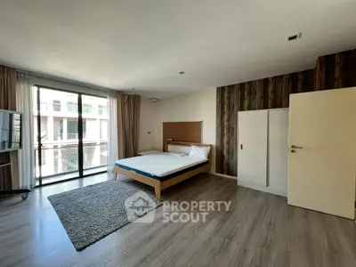 Spacious modern bedroom with large windows and stylish decor