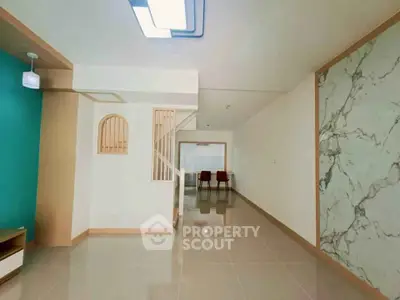 Spacious modern living room with stylish decor and ample natural light.