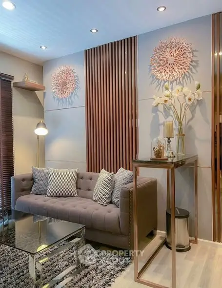 Stylish living room with modern decor, plush sofa, and elegant wall art, perfect for cozy relaxation.