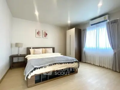 Spacious modern bedroom with natural light and stylish decor