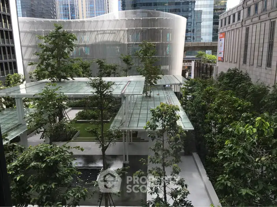 Modern urban garden with lush greenery and sleek architecture in a city setting.