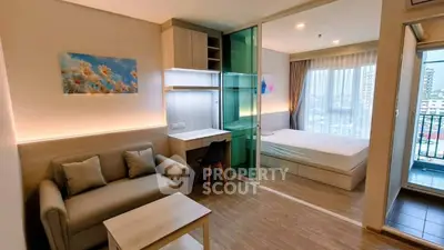 Modern studio apartment with cozy living area and balcony view