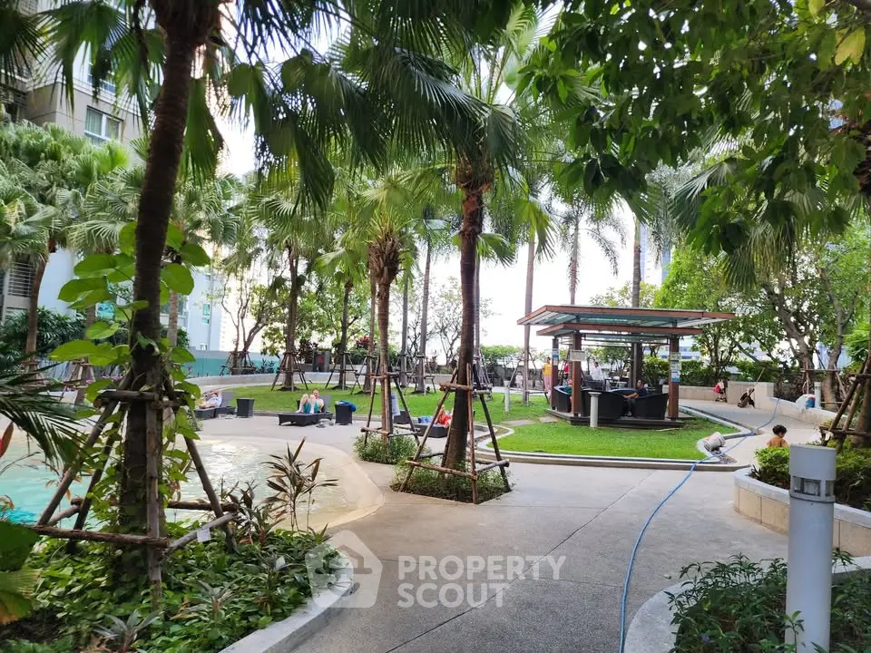 Luxurious garden area with poolside relaxation and lush greenery in a modern residential complex.