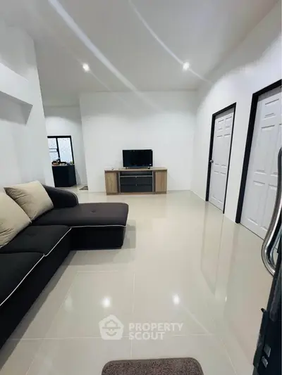Modern living room with sleek black sofa and minimalist decor