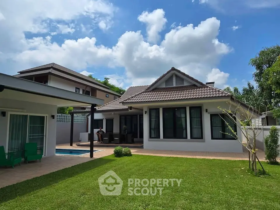 Charming suburban home with lush green lawn and modern architecture under a clear blue sky.
