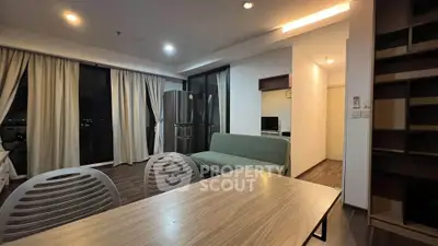Modern living room with dining area and large windows in stylish apartment