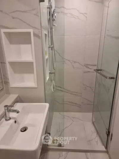 Modern bathroom with sleek shower and elegant marble tiles