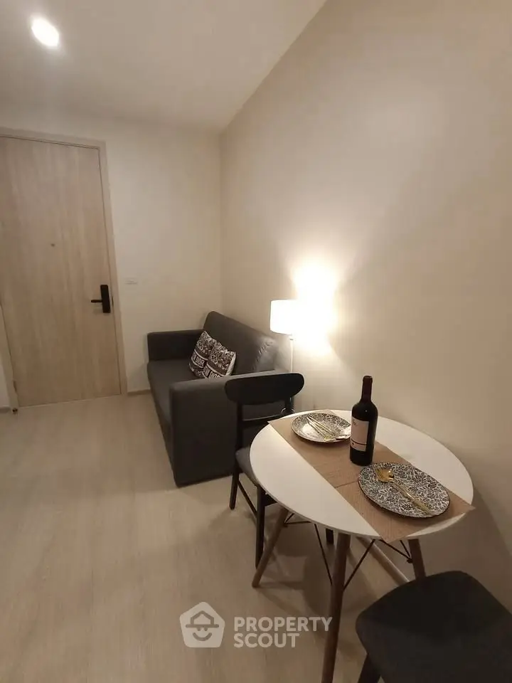 Cozy living room with modern decor and dining area, perfect for urban living.