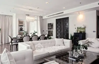 Luxurious open-plan living and dining area with elegant decor and modern furnishings.
