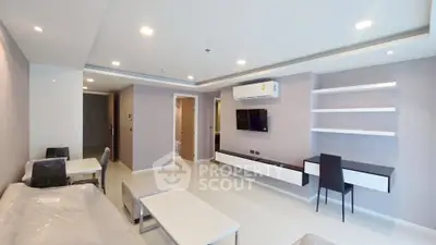 Modern living room with sleek furniture and wall-mounted TV in a stylish apartment.