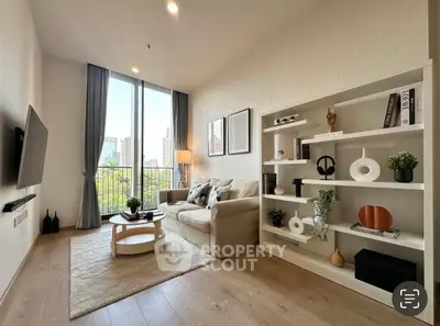 Modern living room with large window and stylish decor in urban apartment.