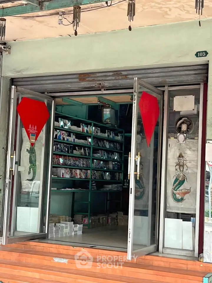 Charming storefront with open glass doors and inviting interior showcasing shelves filled with colorful items.