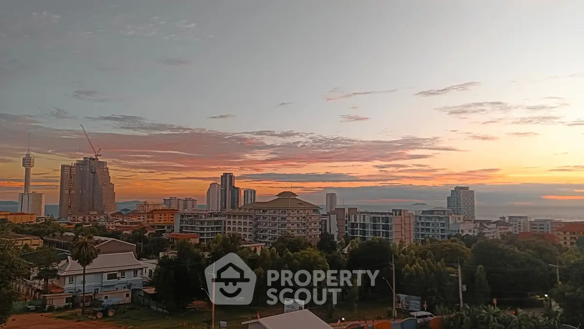 Stunning cityscape view at sunset with modern buildings and lush greenery.