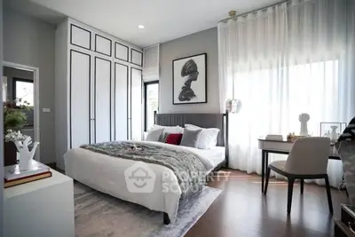 Luxurious bedroom with modern decor, large windows, and elegant furnishings.