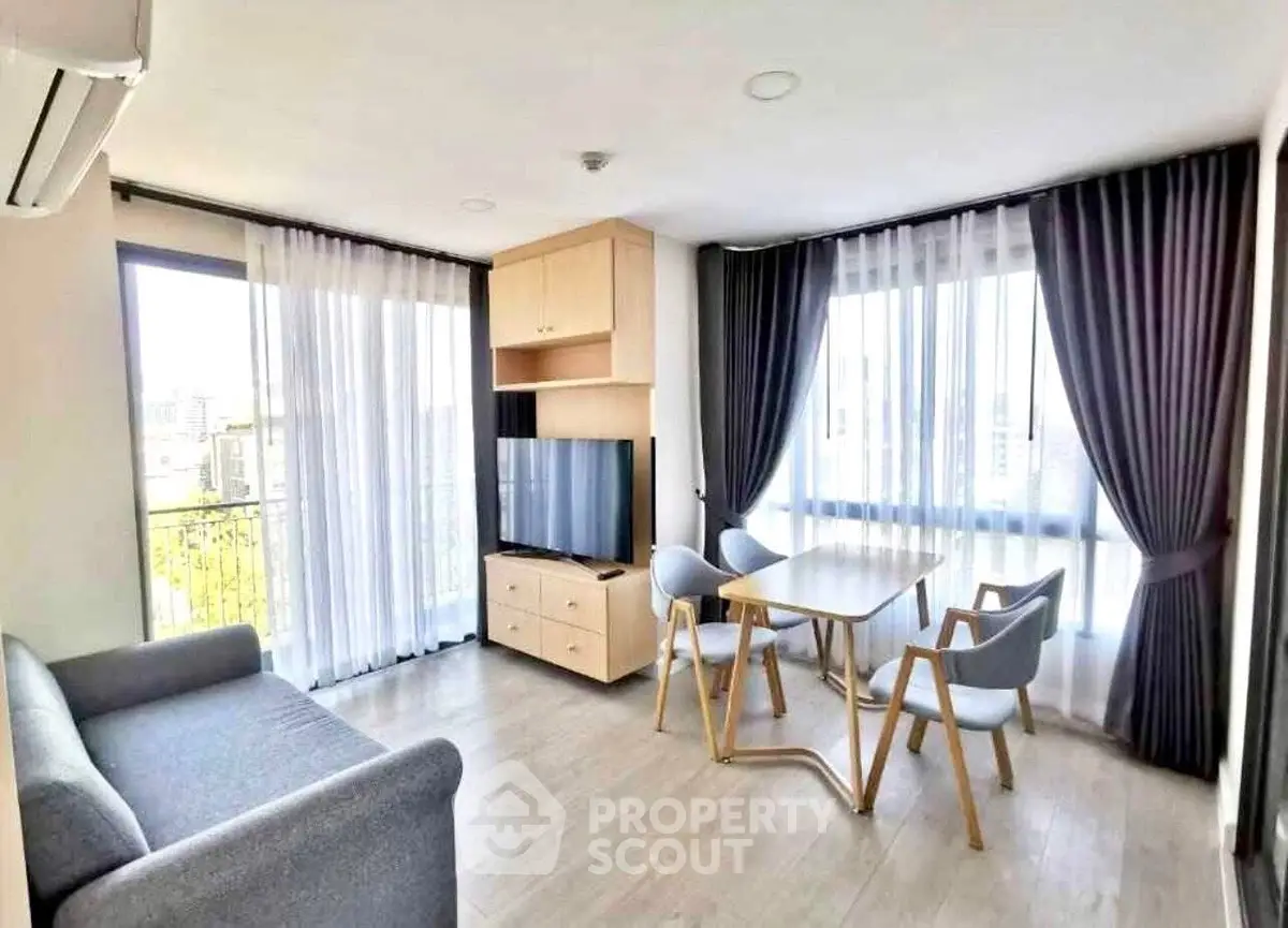 Bright modern living room with large windows and stylish furniture