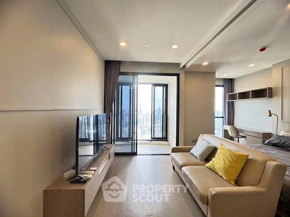 Modern living room with city view, featuring sleek furniture and large windows for natural light.