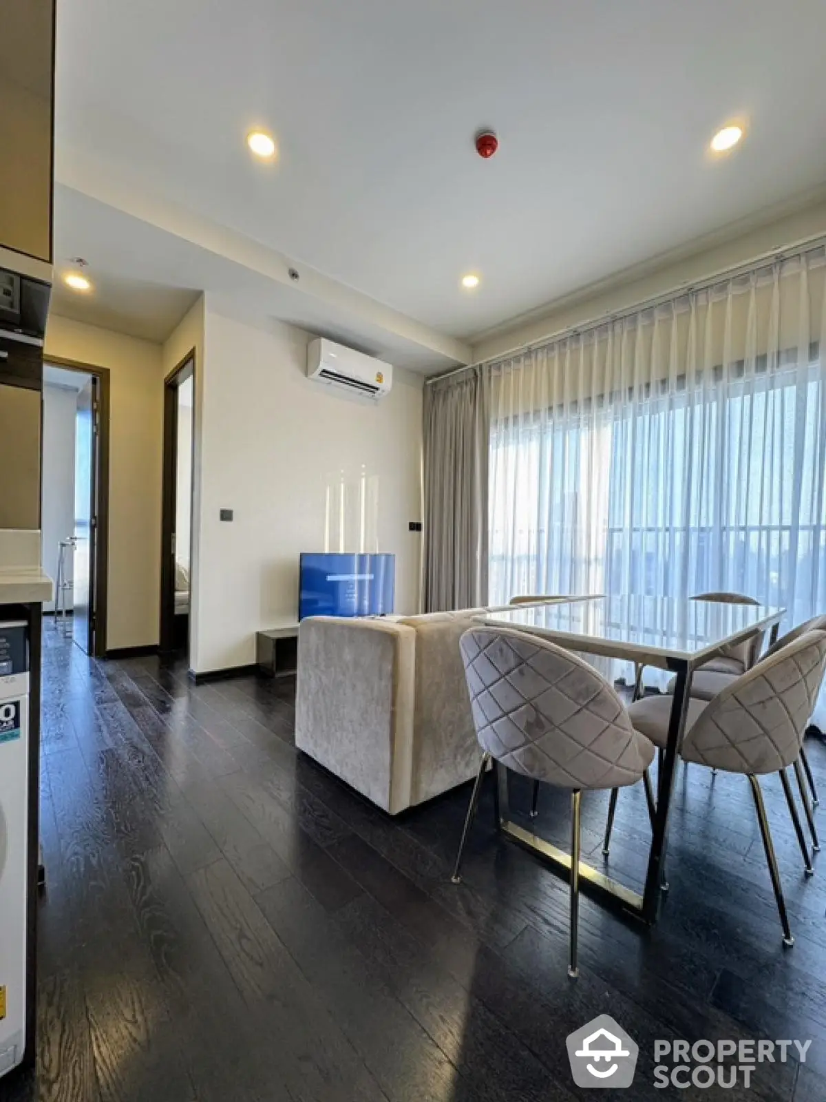 Modern living room with elegant dining area and large windows in a stylish apartment