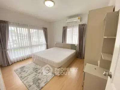 Spacious bedroom with large windows and modern decor