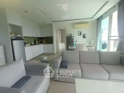 Spacious open-plan living room and kitchen with modern appliances and stylish decor.