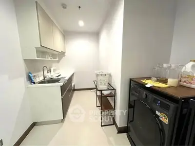 Compact kitchen with modern appliances and sleek cabinetry