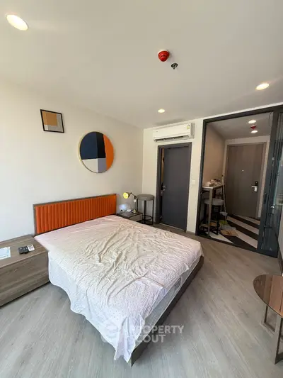 Modern bedroom with stylish decor and air conditioning in a contemporary apartment.