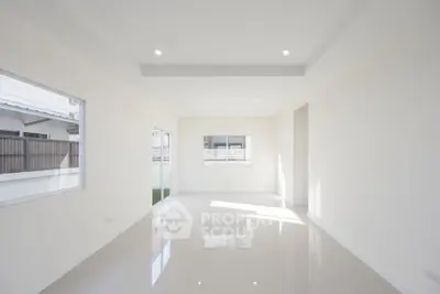 Spacious and bright empty room with large windows and glossy tiled floor, perfect for customization.