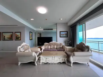 Luxurious living room with elegant furniture and stunning ocean view balcony.