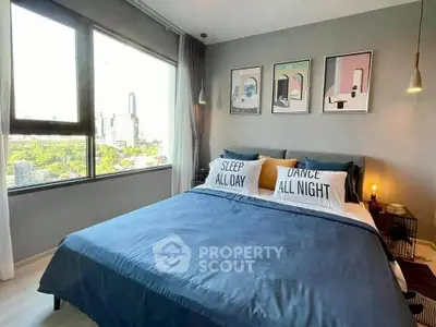 Stylish bedroom with large windows and modern decor in urban apartment