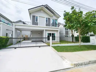 Modern two-story house with spacious driveway and lush greenery