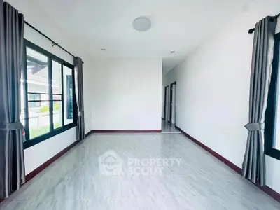 Spacious and bright empty room with large windows and modern flooring