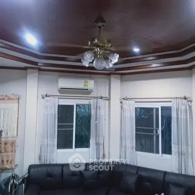 Elegant living room with stylish ceiling and cozy black sofa