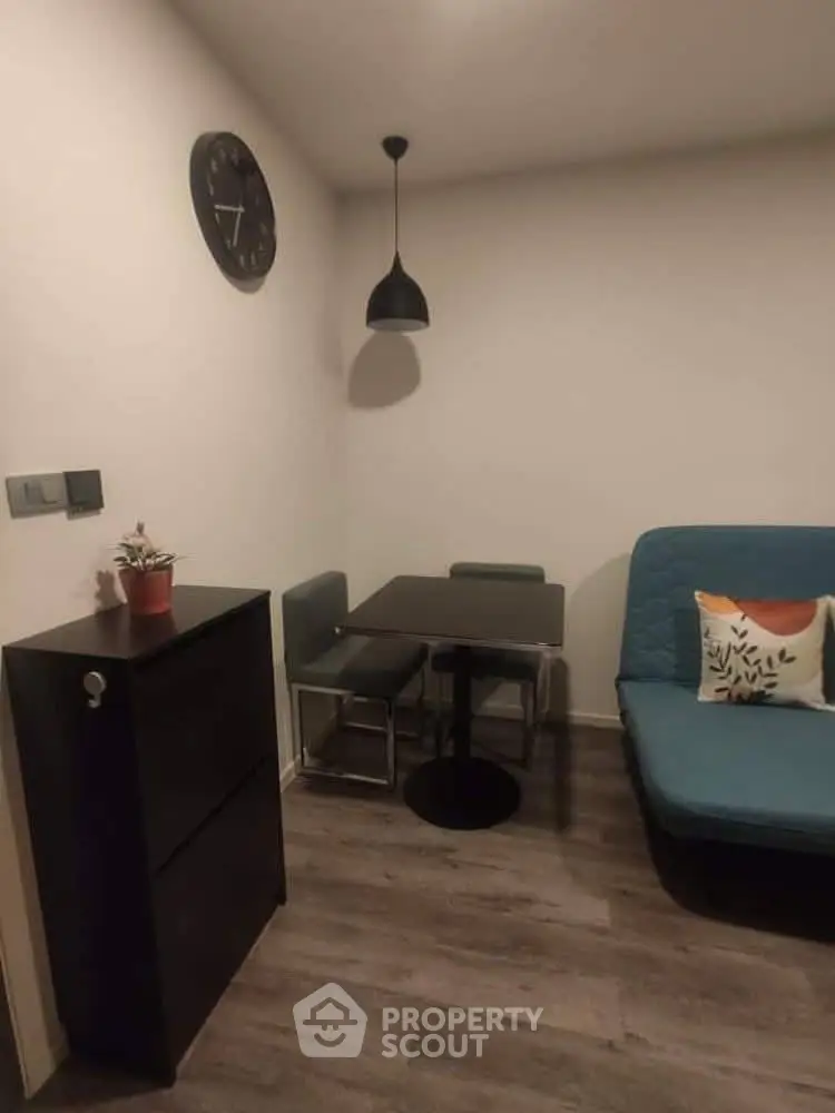 Cozy living room with modern decor and compact dining area