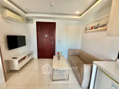 Modern living room with sleek furniture and wall-mounted TV