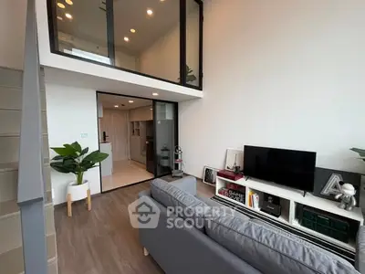 Modern loft-style living room with high ceilings and stylish decor