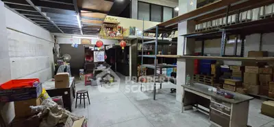 Spacious storage area with shelves and boxes, ideal for warehouse or commercial use.