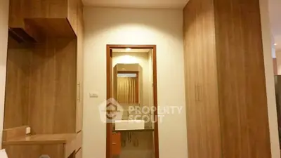 Modern wooden-themed bathroom with stylish sink and mirror
