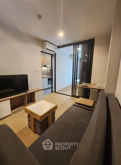 Modern living room with open kitchen and sleek furniture design