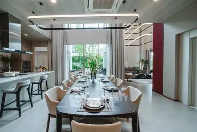 Luxurious open-plan dining and living area with modern decor and natural light.