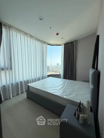 Modern bedroom with panoramic city view and sleek furnishings