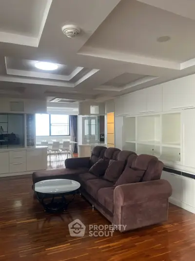 Spacious living room with elegant brown sofa and modern ceiling design