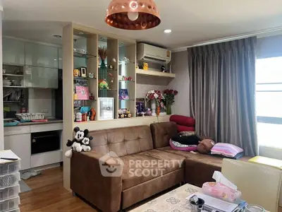 Cozy living room with sectional sofa and open kitchen layout, perfect for modern living.