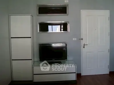 Modern living room with sleek TV stand and storage cabinet, perfect for urban living.