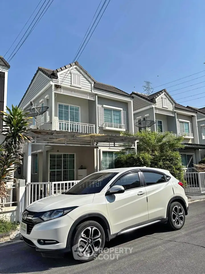 Charming townhouse with modern design and spacious driveway in a serene neighborhood.