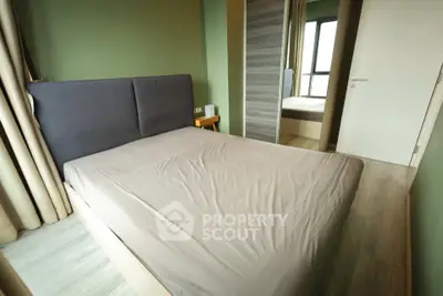 Cozy bedroom with modern design and ample natural light, featuring a comfortable bed and stylish decor.