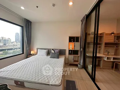 Modern bedroom with city view and adjacent study area