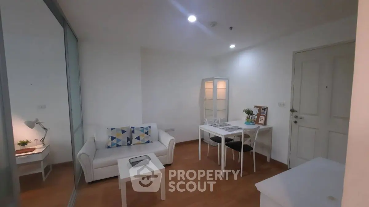 Cozy living room with modern decor and dining area in a stylish apartment.