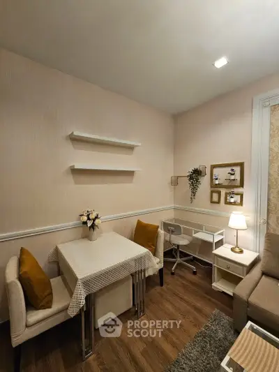 Cozy living room with elegant decor, featuring a small dining area and stylish furniture.