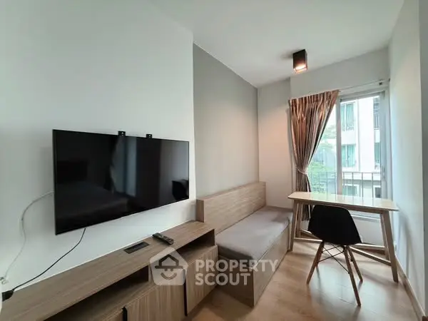 Modern living room with wall-mounted TV and cozy seating area